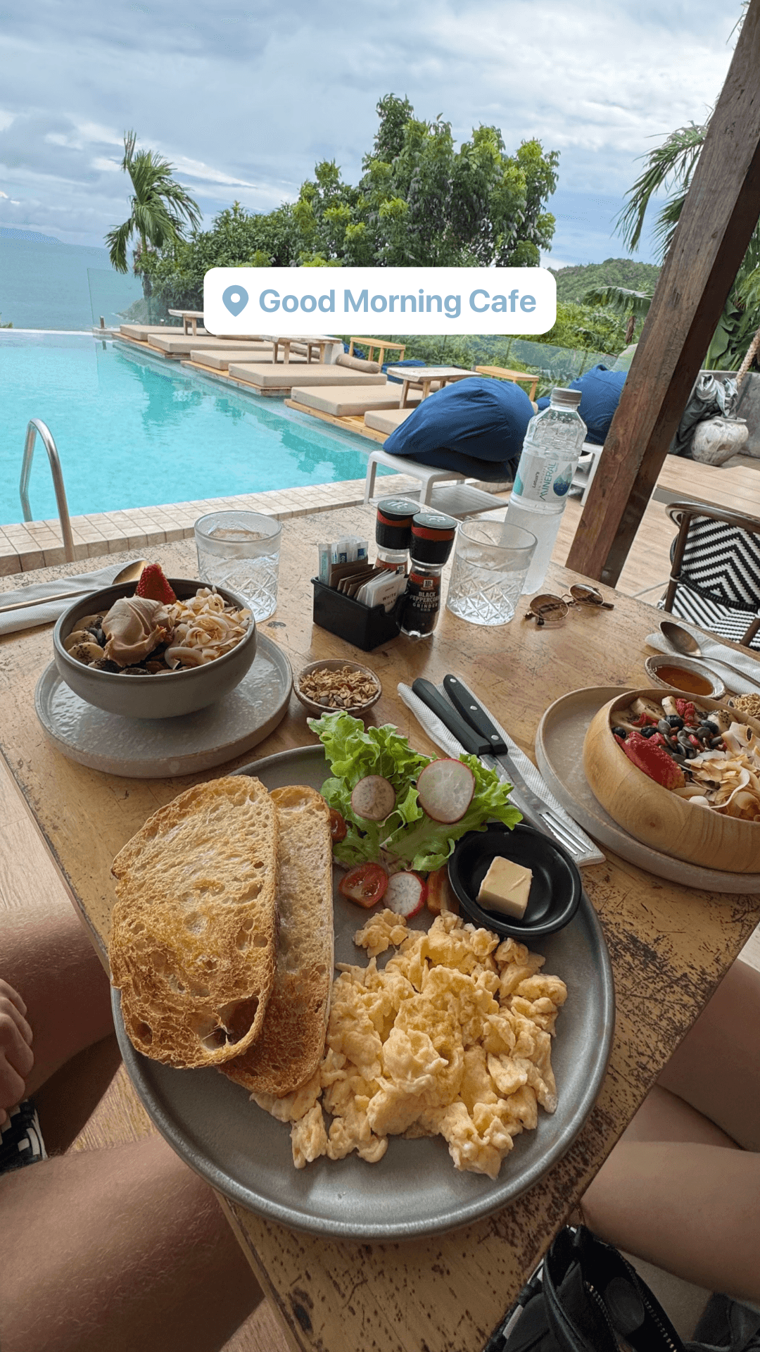 Brunch spread with scrambled eggs, toast, and fresh fruit by the pool at Good Morning Cafe
