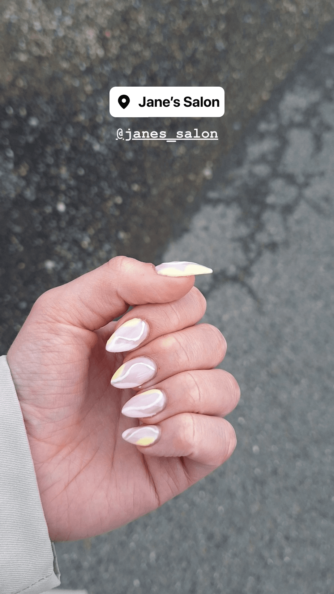 Pastel almond nails with yellow accents posted by a client at Jane's Salon